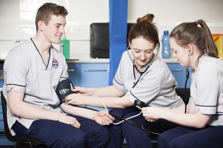 Nursing students learning how to take blood pressure