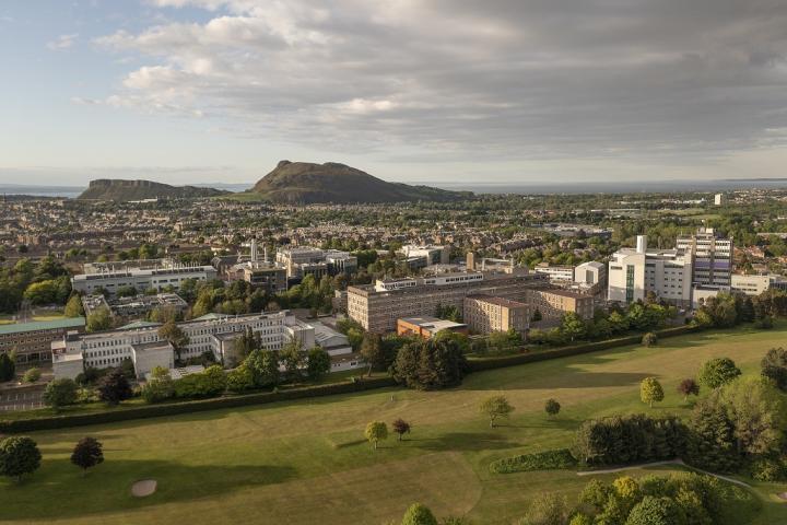 An aerial view of the King's Buildings campus with the city and Arthur's Seat in the background.