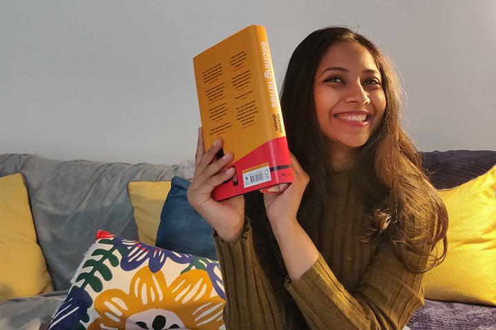Photo of Bhavika Govil holding her book