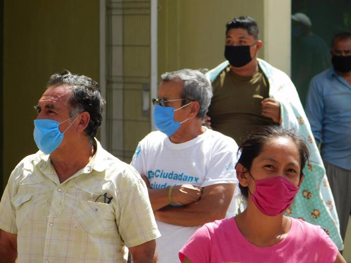 People wearing face coverings and masks.