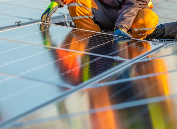 Worker fitting solar panels