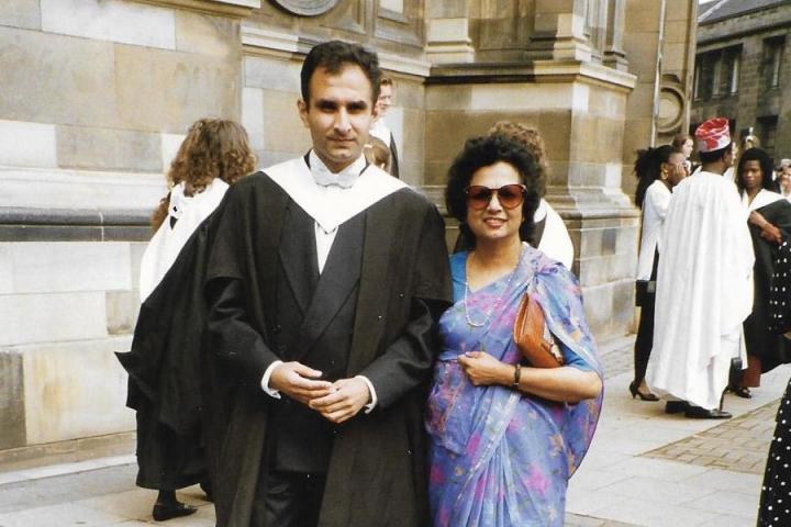 Vineet Lal in graduation robes with his mother, Saroj Lal, in a purple sari outside McEwan Hall.