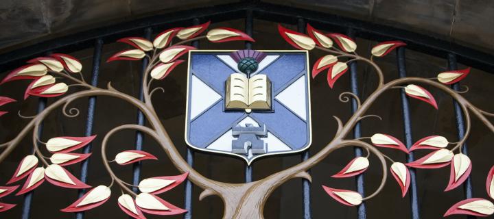 Colour photo of the crest above New College gates 
