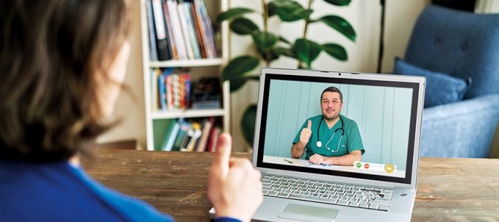 A patient speaking to a healthcare professional using a video call on a laptop