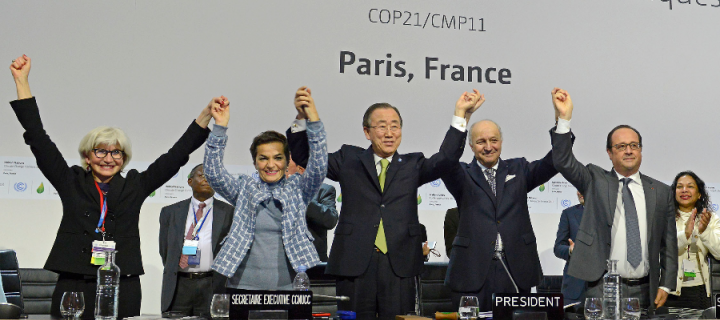 Panel of world leaders at the 2015 UN Paris Climate Change Agreement Conference event standing and cheering