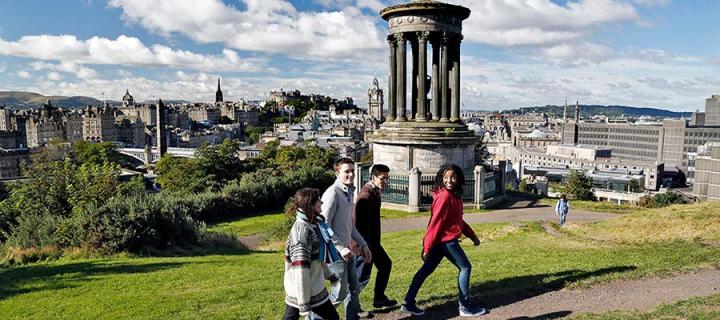Undergraduate students on Edinburgh's Calton Hill, overlooking the city centre