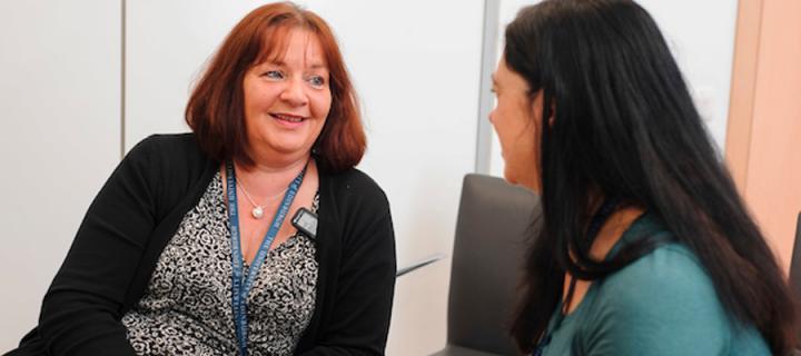 a patient in discussion with a research nurse