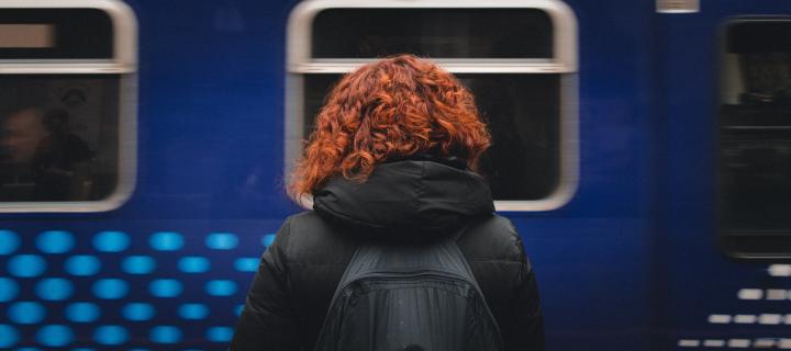 Woman with ginger hair in front of Scotrail train