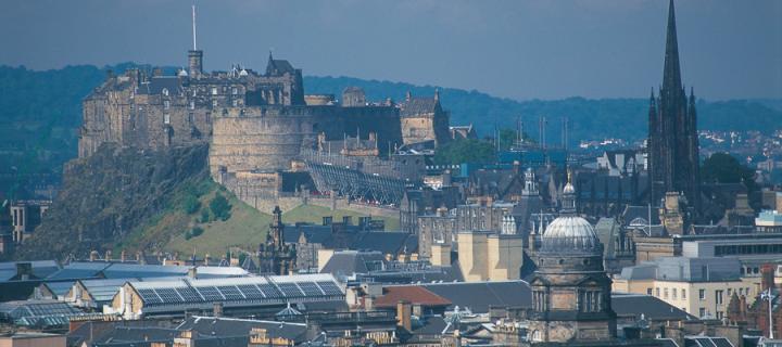 Edinburgh castle with the dome of Old College in the foreground.
