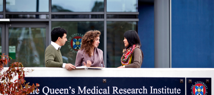 Photograph showing people chatting outside the Queen's Medical Research Institute