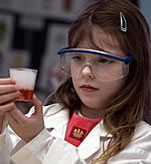 Child in lab coat and safety glasses