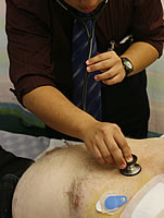 Doctor using a stethoscope on a patient