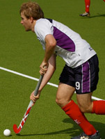Graham Moodie running with hockey stick and ball