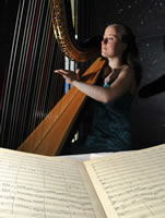 Harpist Julia Somerville, playing an excerpt from the Edinburgh Symphony in the Main Library's Exhibition room.