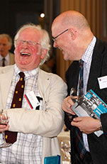 Two alumni laughing