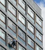Abseiling window cleaner on David Hume Tower