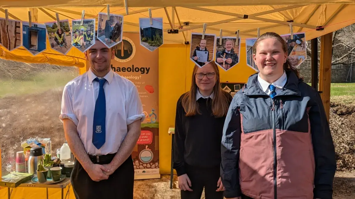 Three school children pictured on site taking part in an Archaeology Scotland Dig 