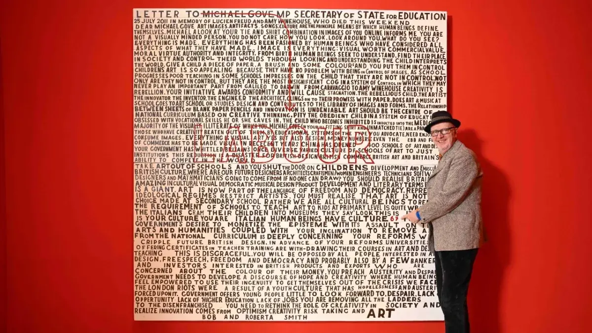 Artist Bob and Roberta Smith pictured with his updated work 'Letter to Michael Gove', re-addressed to the current UK Government.