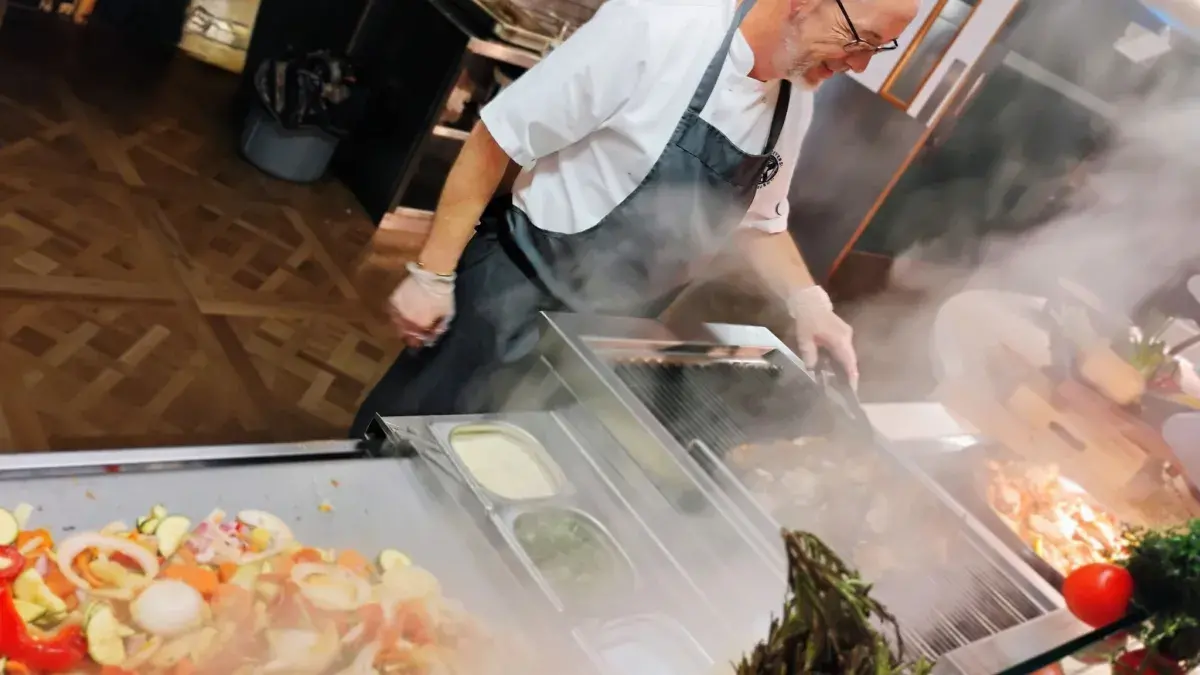 A chef prepares healthy dishes in University accommodation catering. 