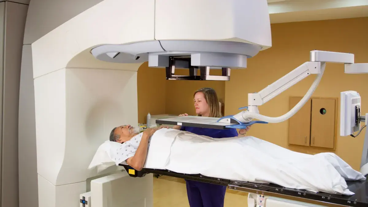 Elderly man receiving radiotherapy treatments for prostate cancer