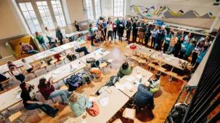 Room full of people reading from pages