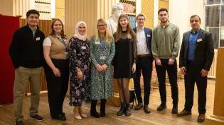 A group of students and university team members at the Education Beyond Borders celebration event.