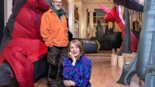 Two artists pose with their work in the Talbot Rice Gallery