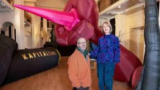 Two artists pose with their work in the Talbot Rice Gallery