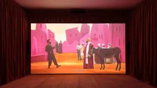 A still of a large-scale film installation playing inside a gallery space.