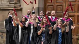 Graduates from the HCP-Med programme at the University of Edinburgh throw their degree certificate tubes into the air in front of McEwan Hall, Edinburgh