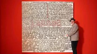 Artist Bob and Roberta Smith pictured with his updated work 'Letter to Michael Gove', re-addressed to the current UK Government.