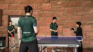 Dr Deng Yaping plays with students from the Table Tennis Society