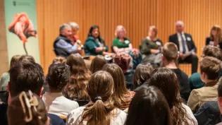 image from the back of an audience of school pupils at a hustings event with councillors from across Edinburgh