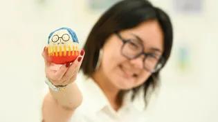Image of ECA graduating student Tiana Sung with a figure