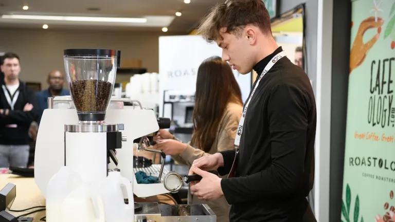 A man makes a coffee as part of the TUCO barista challenge.