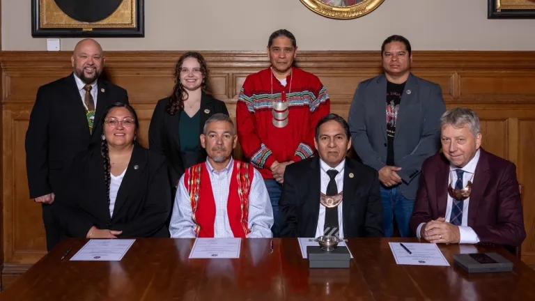 Back Row (L-R): MCN Press Secretary Jason Salsman, MCN Cultural Technician Abigail Dairaghi, MCN Ambassador Jonodev Chaudhuri, MCN Deputy Secretary of Culture & Humanities Anthony Beaver.  Front Row (L-R): MCN Secretary of Culture & Humanities RaeLynn Butler, Second Chief Duck Creek Ceremonial Ground Scott Stafford, MCN Principal Chief David Hill and University of Edinburgh Principal Professor Sir Peter Mathieson. 