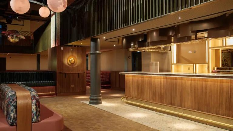 The interior of the new social space created in the building, featuring a bar and seating area