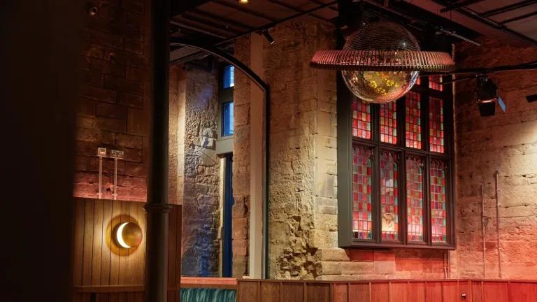 Interior detail of the new Union Social bar with stained glass and disco balls