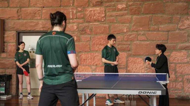 Dr Deng Yaping plays with students from the Table Tennis Society