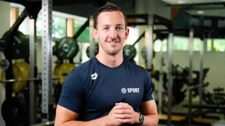 Swimmer Scott Gibson poses in the University gym