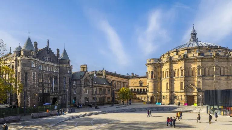 An exterior view across Bristo Square featuring McEwan Hall and the Teviot. 