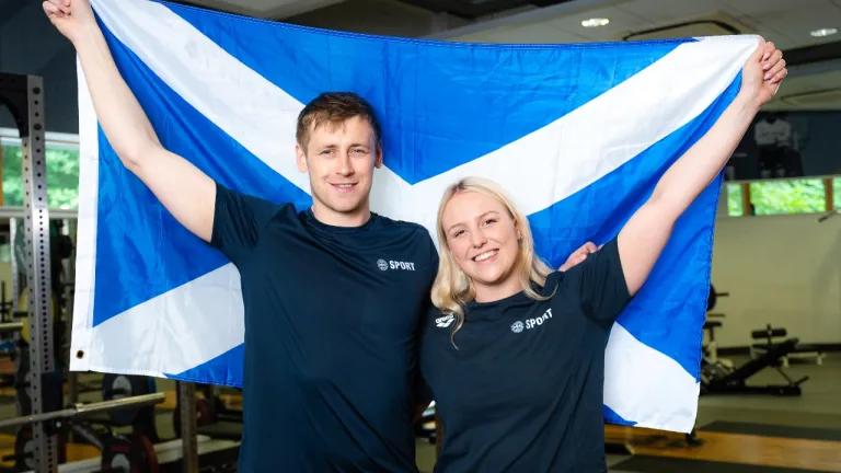 Commonwealth Games medallists, Paraswimmers Stephen Clegg MBE and Faye Rogers pictured in the University performance gym holding a Scottish flag