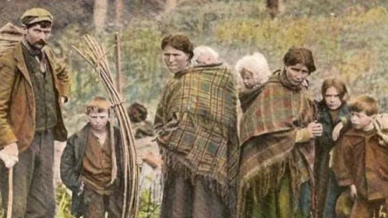George McPhee and family with sticks for a bow tent, c 1910