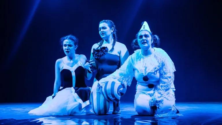 A group of students on stage in a fringe production