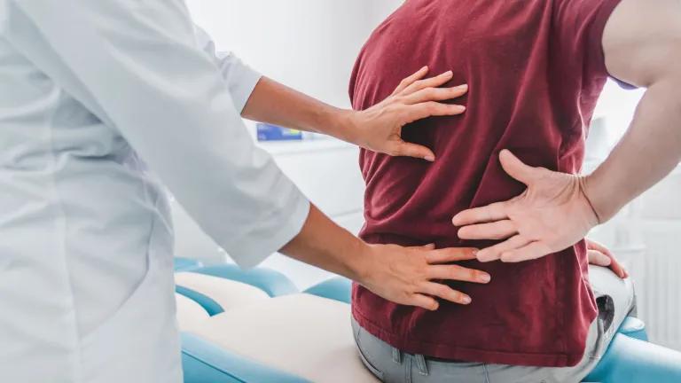 Close up of doctor examining patient's back