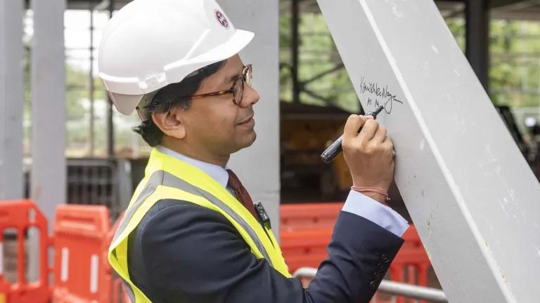 Minister Narayan signs steel beam