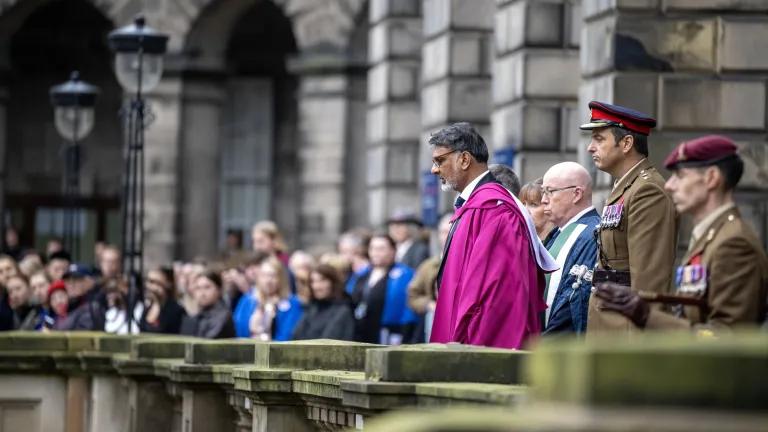 Crowds, led by a chaplain observe a two-minute silence next to the War Memorial at Old College, Edinburgh