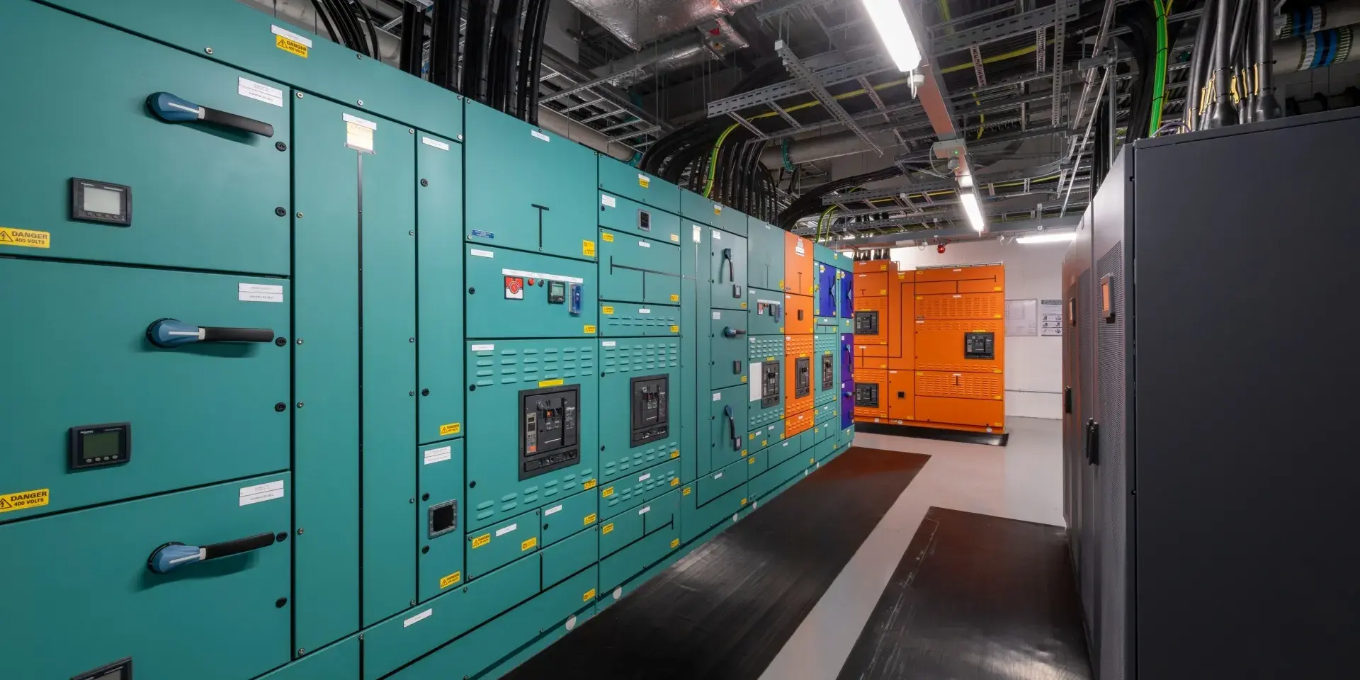 A large room and cabinets housing the supercomputing infrastructure at the University's Advanced Computing Facility.
