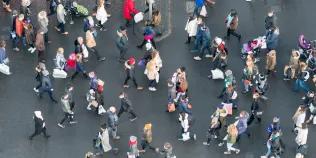 Aerial view of a crowd of pedestrians crossing a street in central Edinburgh