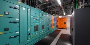 A large room and cabinets housing the supercomputing infrastructure at the University's Advanced Computing Facility.